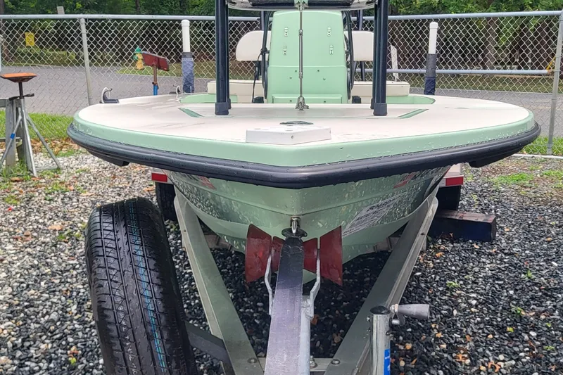 Slide: The Image of 2019 Maverick Mirage 18 HPX-V boat on trailer, parked on gravel. - 6