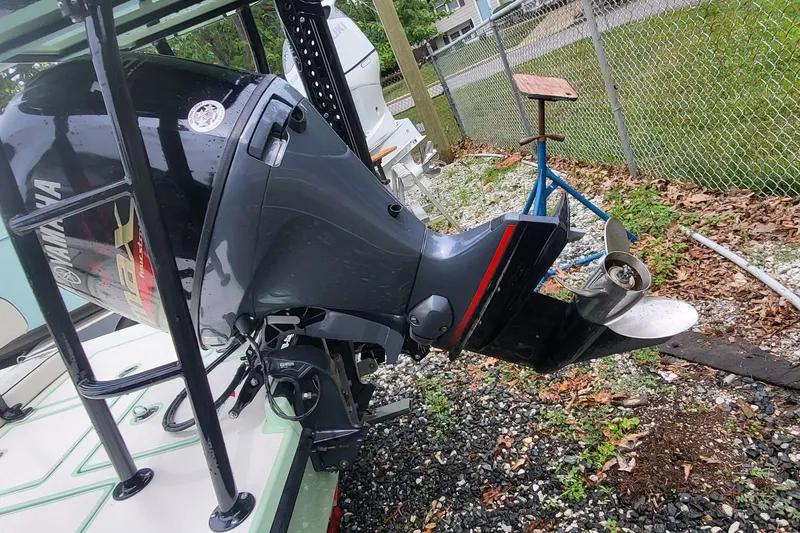 Slide: The Image of 2019 Maverick Mirage 18 HPX-V boat with Yamaha outboard motor in a yard setting. - 7