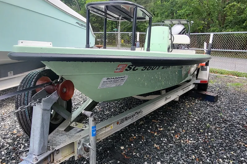 The Image of 2019 Maverick Mirage 18 HPX-V boat on trailer, parked on gravel, with green hull. - 0