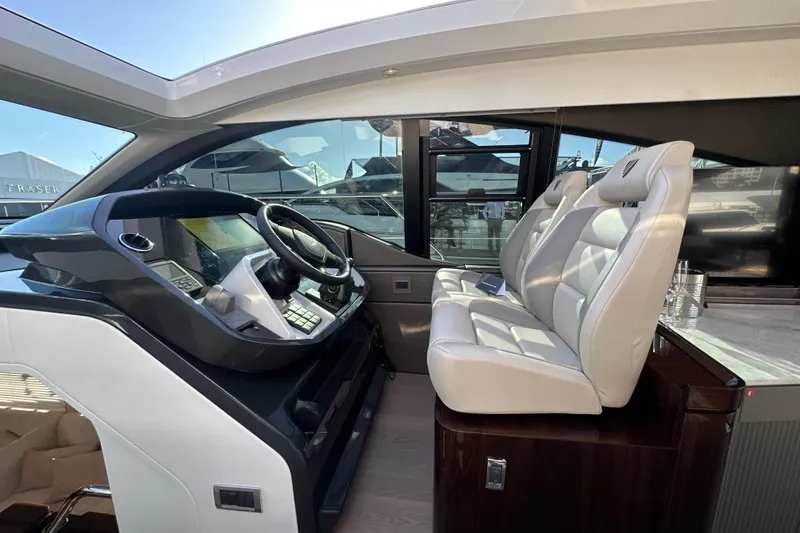 Slide: The Image of Interior of 2026 Fairline Targa 47 GT yacht with modern helm and plush seating. - 22