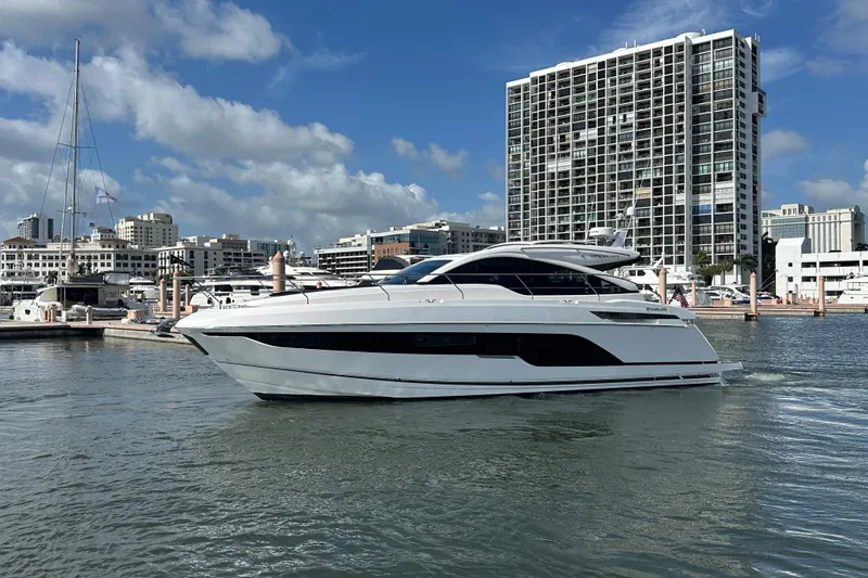 Slide: The Image of 2026 Fairline Targa 47 GT yacht docked in urban marina with cityscape backdrop. - 1