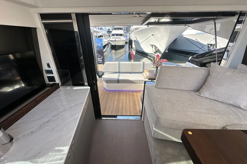 Slide: The Image of Luxurious interior of 2026 Fairline Targa 47 GT yacht with marina view. - 47