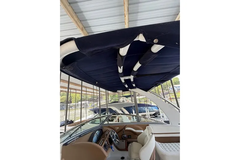 Slide: The Image of 2018 Cobalt R5 boat interior with canopy, docked under a covered marina. - 10