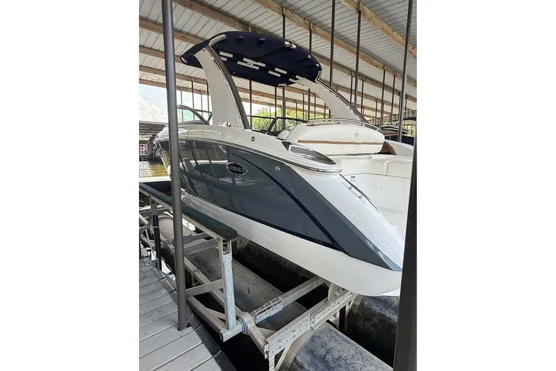 Slide: The Image of 2018 Cobalt R5 boat docked in a covered marina, showcasing sleek design and modern features. - 2