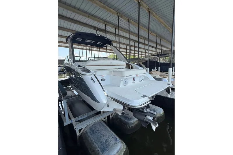 Slide: The Image of 2018 Cobalt R5 boat in covered dock, showcasing sleek design and spacious deck. - 5