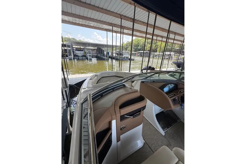 Slide: The Image of 2018 Cobalt R5 boat interior at a marina, showcasing helm and seating area. - 8