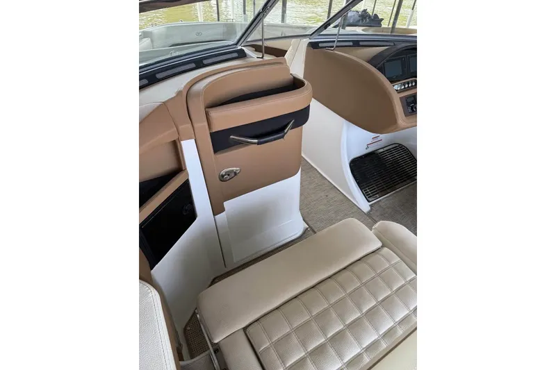 Slide: The Image of Interior of a 2018 Cobalt R5 boat, featuring tan and white seating and dashboard. - 11