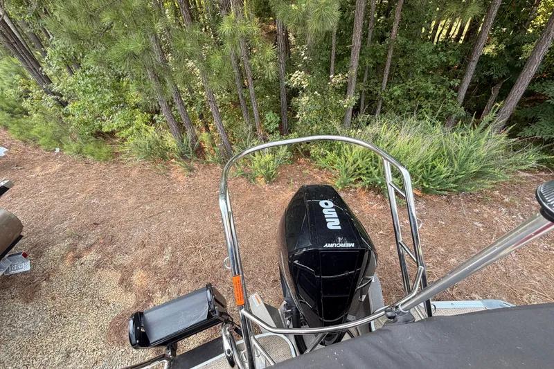 Slide: The Image of 2023 Crest Carribbean 250 SLC boat with Mercury engine, surrounded by lush forest. - 3