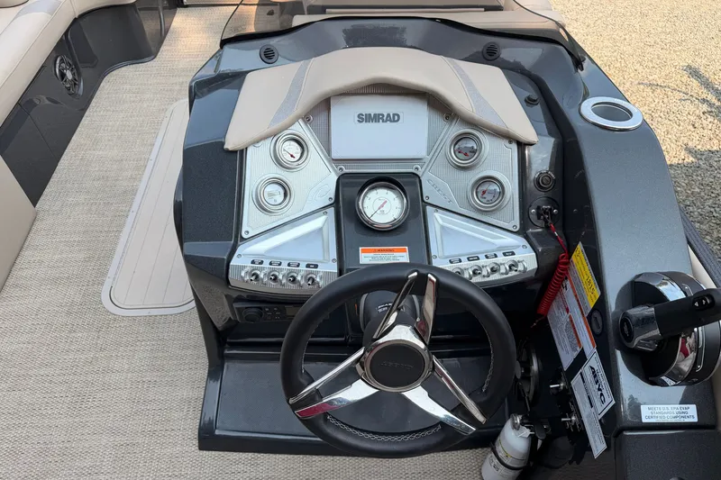 Slide: The Image of 2023 Crest Carribbean 250 SLC boat dashboard with steering wheel and control panel. - 4