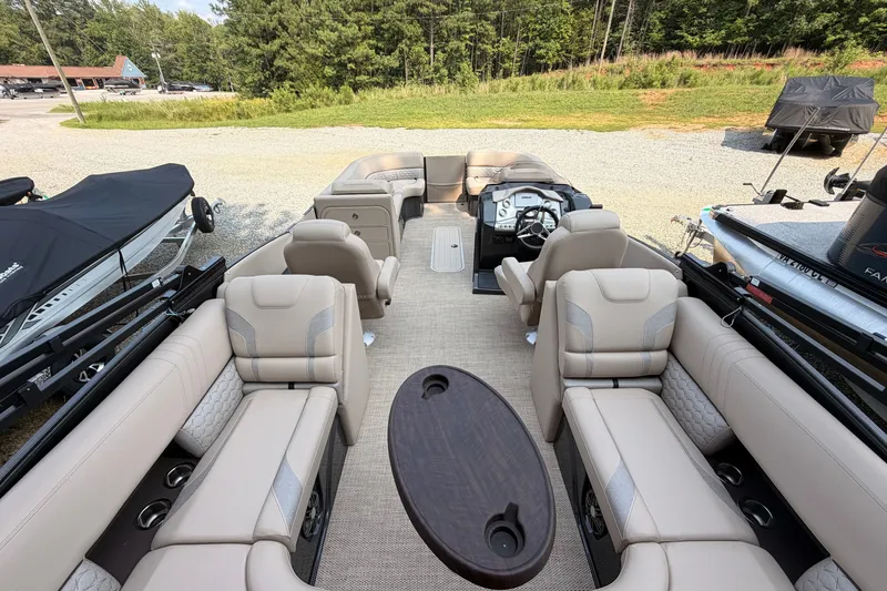 Slide: The Image of 2023 Crest Carribbean 250 SLC pontoon boat interior with luxurious seating and steering console. - 5