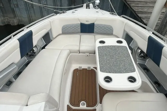 Slide: The Image of 2013 Chaparral 327 SSX boat interior with cushioned seating and table. - 5