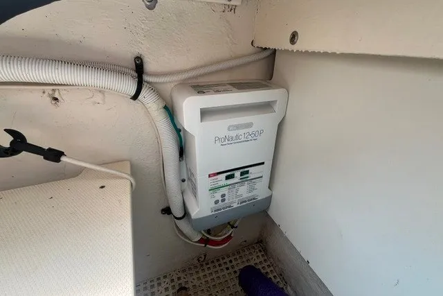Slide: The Image of Battery charger installed in a 2013 Chaparral 327 SSX boat compartment. - 12
