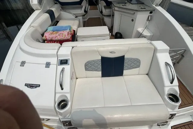 Slide: The Image of 2013 Chaparral 327 SSX boat interior with white seating and modern amenities. - 38