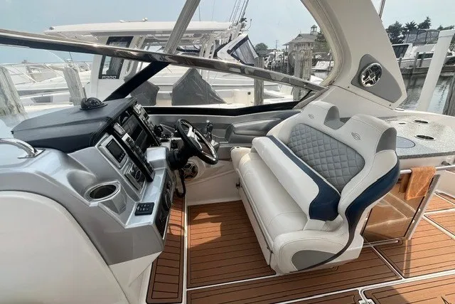 Slide: The Image of 2013 Chaparral 327 SSX boat interior with luxury seating and modern dashboard. - 16