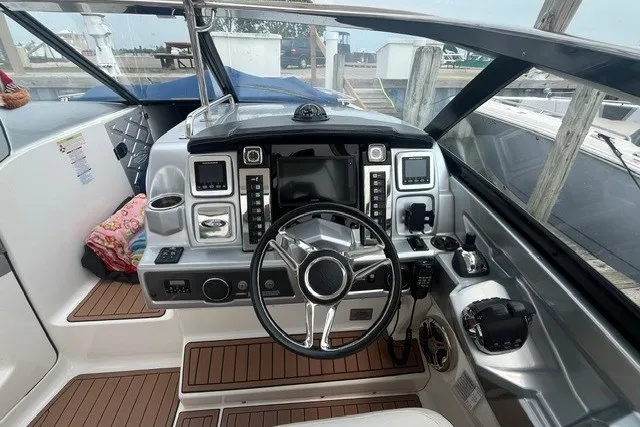 Slide: The Image of 2013 Chaparral 327 SSX boat cockpit with modern controls and steering wheel. - 22