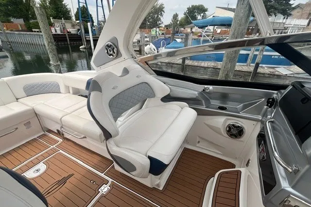 Slide: The Image of Luxurious 2013 Chaparral 327 SSX boat interior with plush seating and elegant wood flooring. - 18