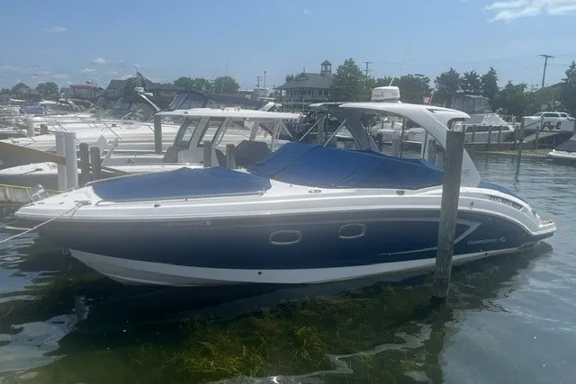 Slide: The Image of Chaparral 327 SSX 2013 boat docked in a marina under a clear sky. - 1