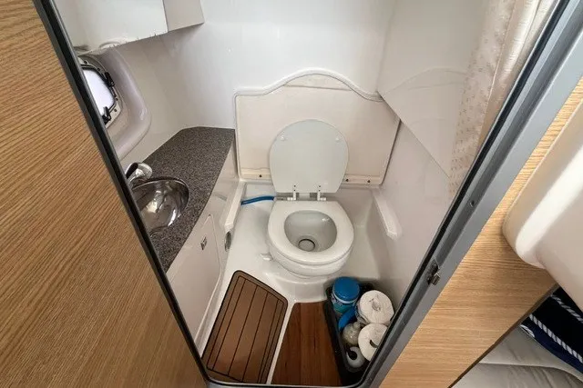 Slide: The Image of Compact bathroom in 2013 Chaparral 327 SSX boat with toilet and sink. - 30