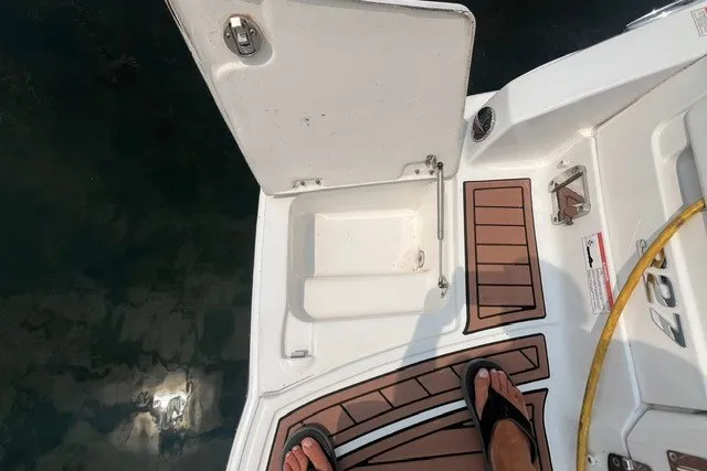 Slide: The Image of Open hatch on 2013 Chaparral 327 SSX boat deck with teak flooring. - 36
