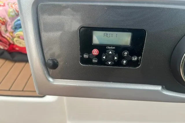 Slide: The Image of Control panel of a 2013 Chaparral 327 SSX boat with Clarion audio system. - 23