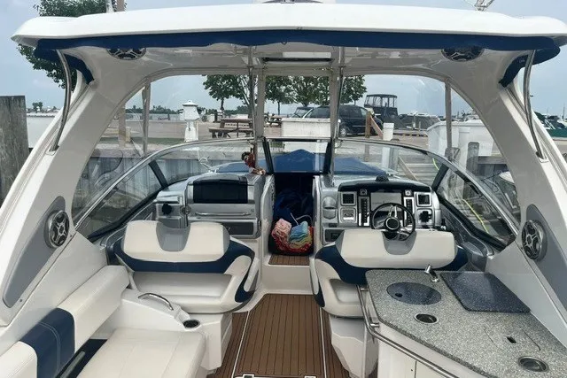 Slide: The Image of 2013 Chaparral 327 SSX boat interior with luxurious seating and modern dashboard. - 14