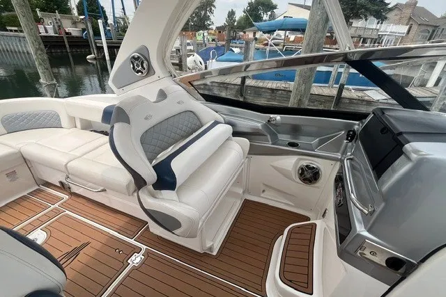 Slide: The Image of 2013 Chaparral 327 SSX boat interior with luxurious seating and sleek dashboard design. - 17