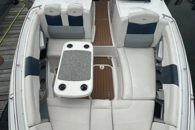 Slide: The Image of 2013 Chaparral 327 SSX boat interior with white seating and a central table. - 6