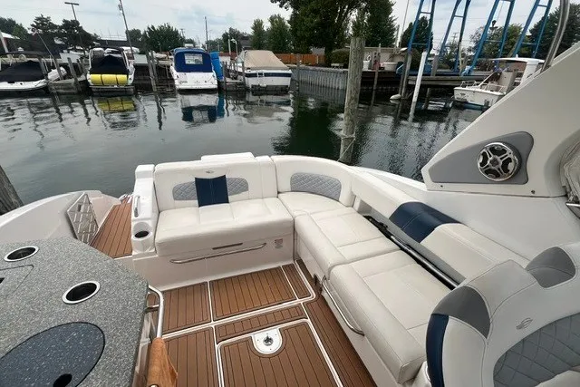 Slide: The Image of 2013 Chaparral 327 SSX boat with spacious seating at a marina. - 19