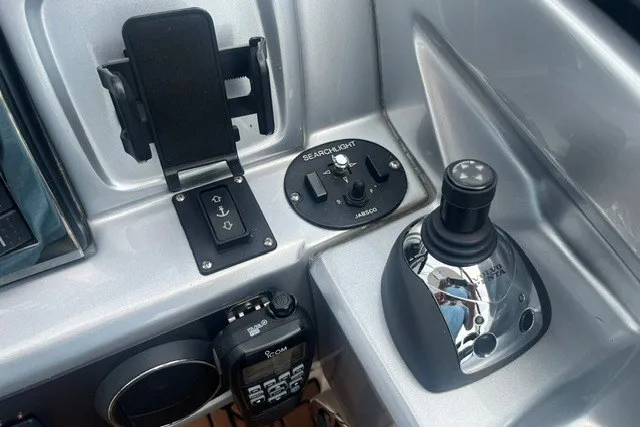 Slide: The Image of Control panel of a 2013 Chaparral 327 SSX boat with joystick and searchlight controls. - 26