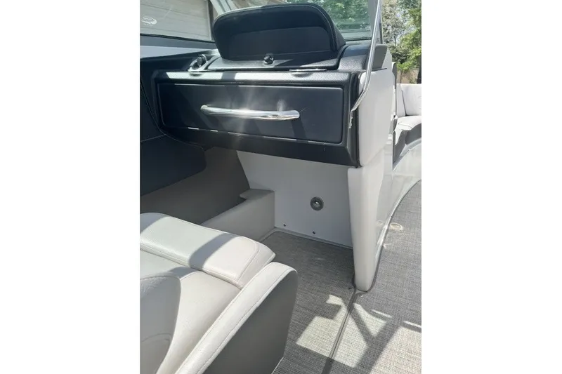 Slide: The Image of 2022 Crownline 240 SS boat interior with sleek seating and modern dashboard design. - 12