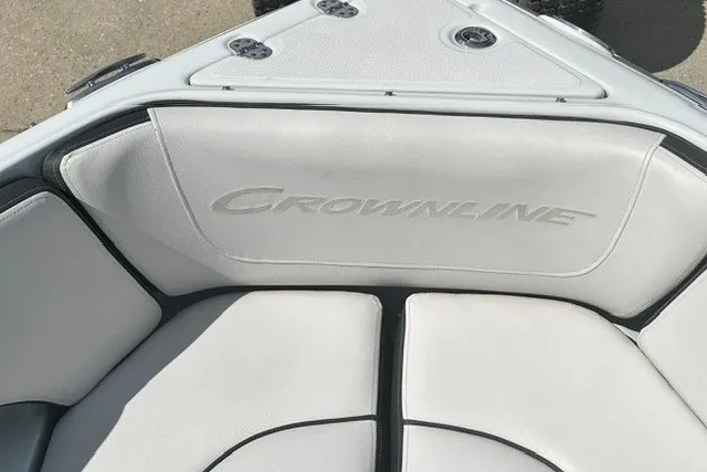 Slide: The Image of 2022 Crownline 240 SS boat interior with white cushioned seating. - 10