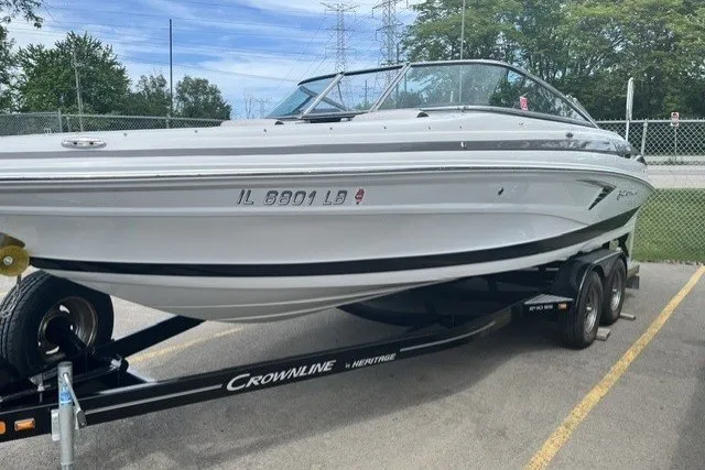 The Image of 2022 Crownline 240 SS boat on trailer in parking lot, side view. - 0