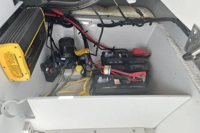 Slide: The Image of Battery compartment of a 2022 Crownline 240 SS boat with wiring and charger. - 8