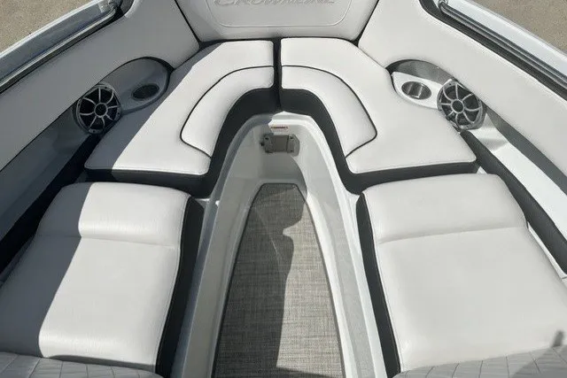 Slide: The Image of 2022 Crownline 240 SS boat interior with white cushioned seating and speakers. - 5