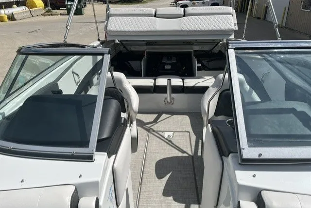 Slide: The Image of 2022 Crownline 240 SS boat interior with open seating and windshield. - 9