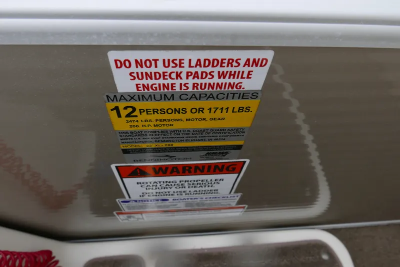 Slide: The Image of 2014 Bennington 2250GSR capacity warning label, maximum 12 persons or 1711 lbs. - 15