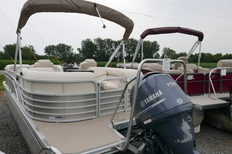 Slide: The Image of 2014 Bennington 2250GSR pontoon boat with Yamaha 150 engine, parked outdoors. - 3