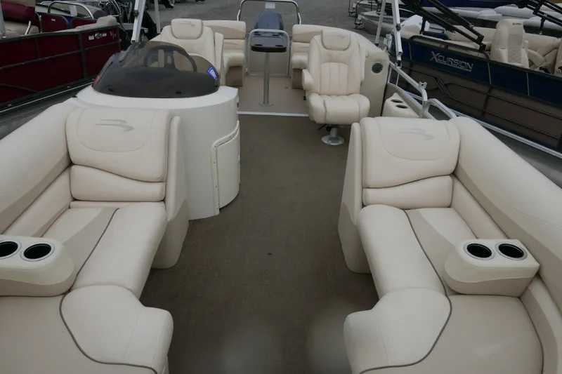 Slide: The Image of 2014 Bennington 2250GSR pontoon boat interior with beige seating and cup holders. - 4