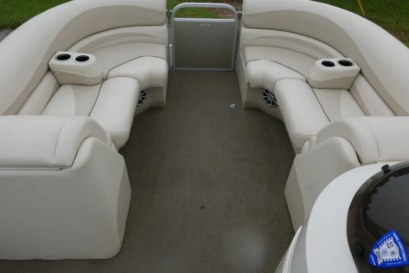 Slide: The Image of 2014 Bennington 2250GSR pontoon boat interior with beige seating and cup holders. - 7