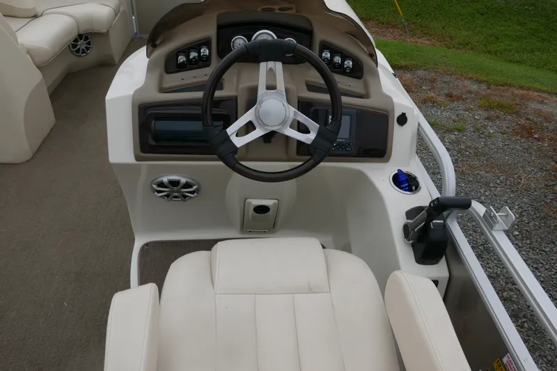 Slide: The Image of Steering console of a 2014 Bennington 2250GSR boat with beige seating and controls. - 10
