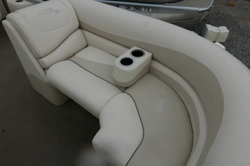 Slide: The Image of 2014 Bennington 2250GSR boat interior with beige seating and dual cup holders. - 5