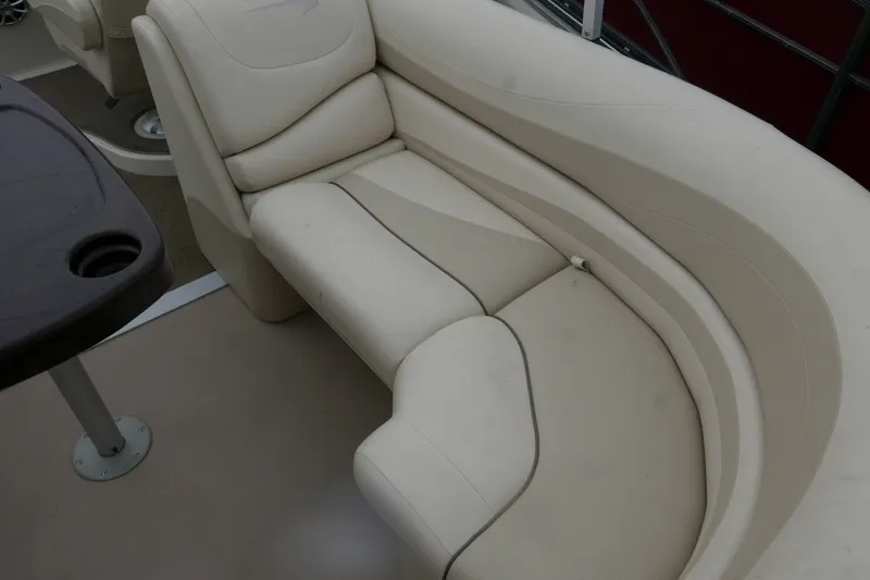 Slide: The Image of 2014 Bennington 2250GSR boat interior with beige seating and table. - 13