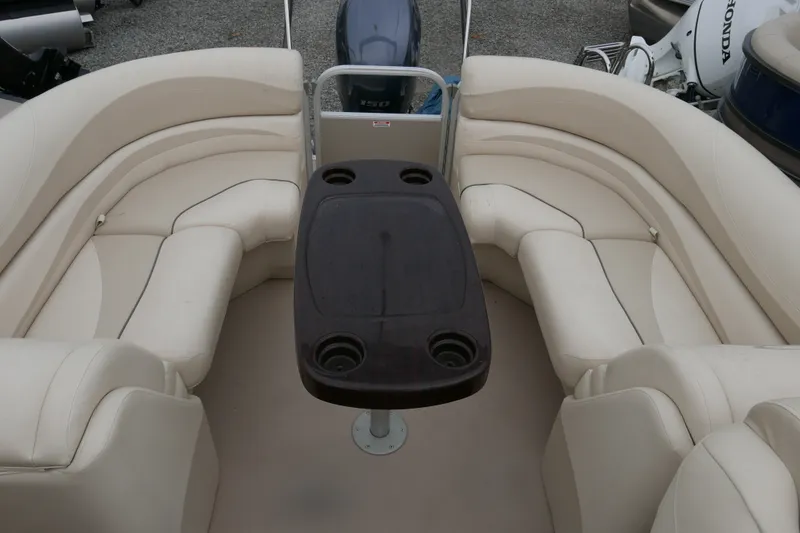 Slide: The Image of 2014 Bennington 2250GSR boat interior with beige seating and central table. - 11