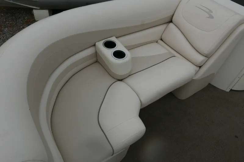 Slide: The Image of 2014 Bennington 2250GSR boat interior with cream leather seating and dual cup holders. - 6