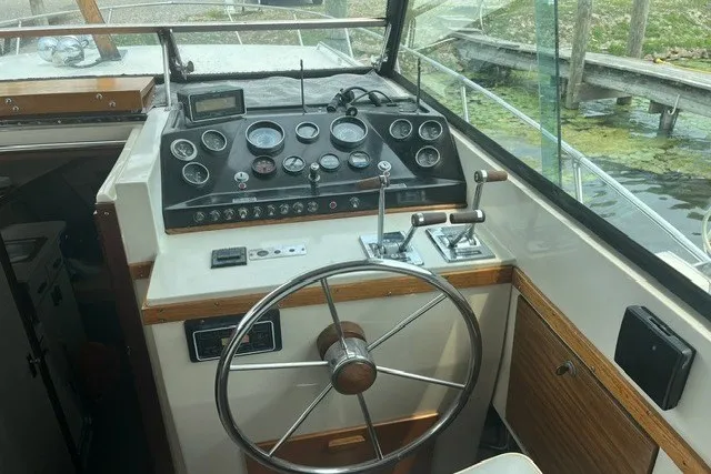 Slide: The Image of 1975 Slickcraft 28 EXPRESS boat cockpit with steering wheel and control panel. - 5