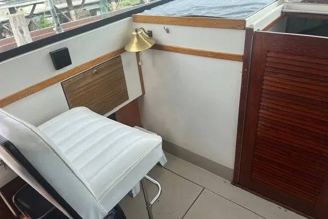 Slide: The Image of Interior of a 1975 Slickcraft 28 EXPRESS boat with white seating and wooden accents. - 6