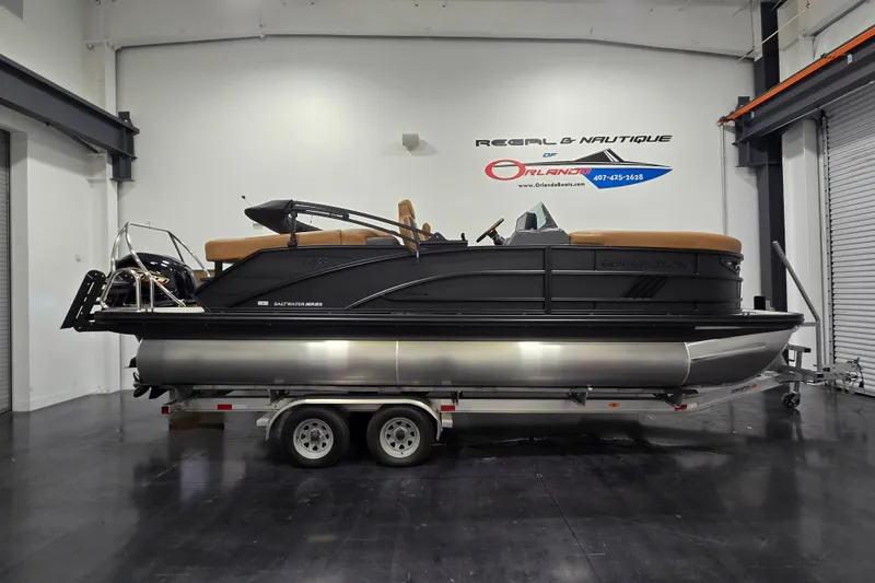 The Image of 2026 Bennington 22M Open FSB pontoon boat on trailer in showroom. - 1