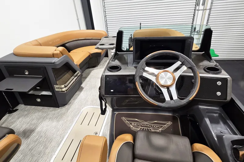 Slide: The Image of 2026 Bennington 22M Open FSB boat interior with modern steering and luxurious seating. - 9