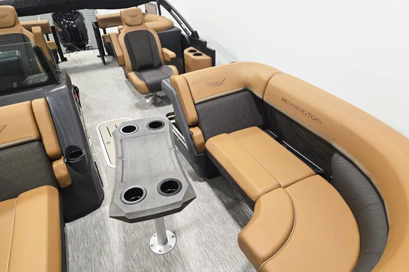 Slide: The Image of Luxurious interior of 2026 Bennington 22M Open FSB pontoon boat with tan seating and table. - 5