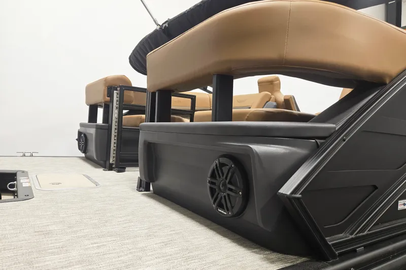 Slide: The Image of 2026 Bennington 22M Open FSB boat interior with tan seating and integrated speaker system. - 4